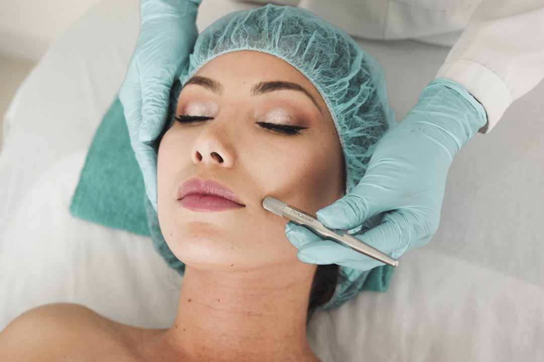 Woman receiving a professional facial skincare treatment at a spa